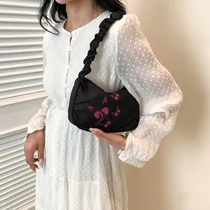 Large black shoulder bag with pink butterflies and pleated strap for women