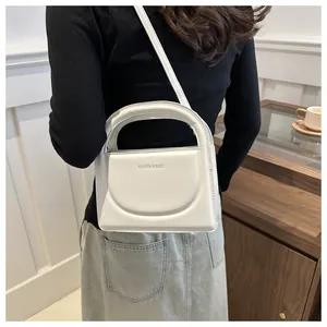 White minimalist crossbody bag with Fashion & Bags text shown in a lifestyle setting