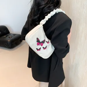 White large capacity shoulder bag with butterfly print and ruffled strap details