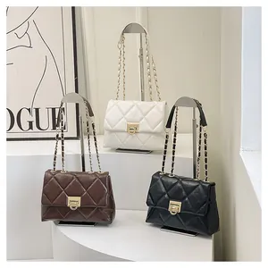 Detailed view of quilted PU leather crossbody bags in black, white, and brown colors
