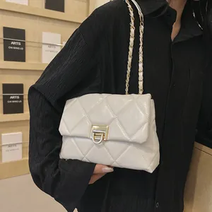 Modern white quilted shoulder bag with gold chain strap and metallic lock closure