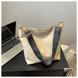 Detail of off-white tote bag with vintage bohemian jacquard strap and gold hardware