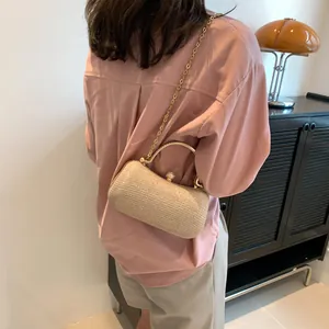 Elegant champagne gold evening clutch bag with metal handle and shimmering texture