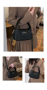Détail du sac à rabat en cuir PU noir avec inscription FASHION dorée et finitions métalliques