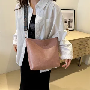 Pink faux leather tote bag with ethnic print shoulder strap and large capacity