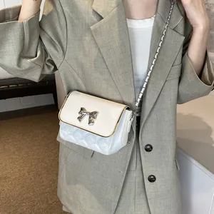 Quilted white crossbody chain bag for women with silver bow accent and elegant metal strap