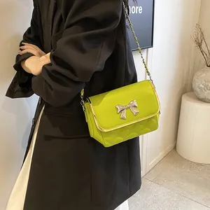 Quilted green crossbody bag for women with silver bow and gold chain strap
