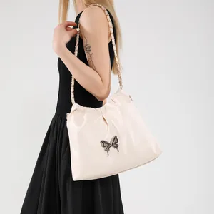 Chic beige shoulder bag with metal butterfly buckle and elegant chain strap for women