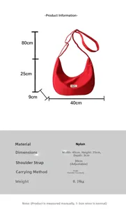 Detail view of red nylon crescent bag with dimension markings and adjustable strap