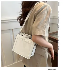 Detailed view of the white Rich Rabbit leather tote bag showing 3D embossed texture