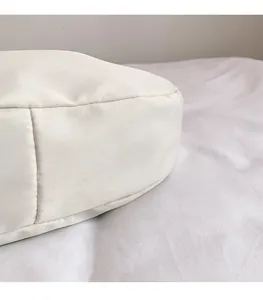 Close-up of clean stitching and high-density waterproof fabric on the white crossbody bag