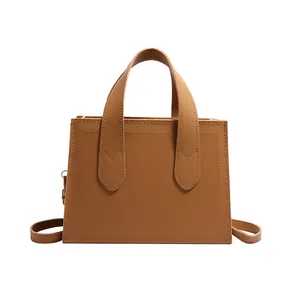 Brown rectangular tote bag with dual handles and adjustable strap on white background