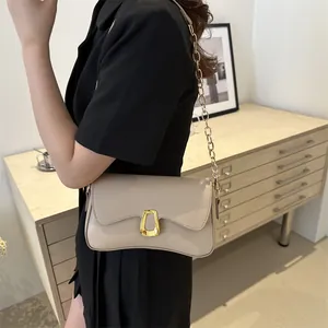 Minimalist beige baguette bag with golden buckle and chain strap for women