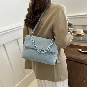 Quilted light blue denim envelope shoulder bag with thick chain strap for women