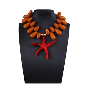 Detail of tropical necklace featuring large brown beads and a bold red starfish pendant