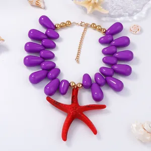 Colorful sea star pendant necklace with purple beads in a bohemian coastal style
