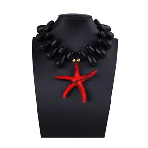 Detailed close-up of chunky black teardrop beads and a vibrant red starfish pendant on display