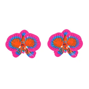 Detailed view of large orchid earrings with vibrant pink orange and blue enamel finish