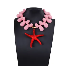 Detailed view of ocean style necklace featuring pink resin beads and a large red starfish pendant