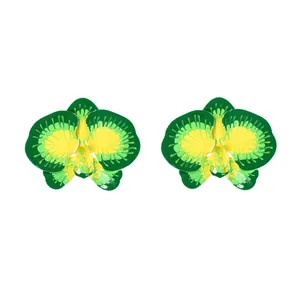 Detail of orchid-shaped earrings featuring vibrant green and yellow enamel over metal finish
