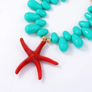 Close-up of red starfish pendant with turquoise water-drop beads on ocean style necklace