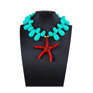 Close-up of ocean style necklace with turquoise teardrop beads and a large red starfish