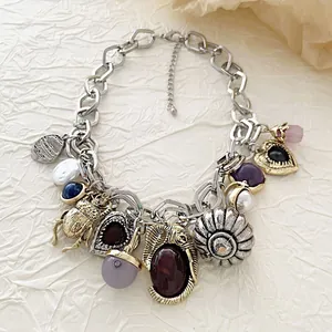 Detailed close-up of retro bohemian chain necklace with beetle and heart charms