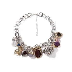Detailed view of vintage chunky chain necklace with eclectic beetle and shell pendants