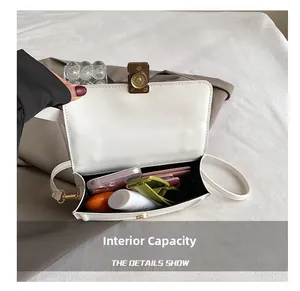 Detail view of white square bag interior capacity showing storage for daily essentials