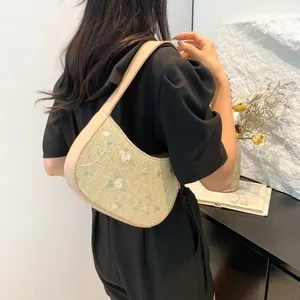 Japanese style woven straw underarm bag with white flower embroidery and leather strap