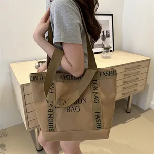 Large khaki canvas tote bag with black Fashion Bag print and dual handles for women