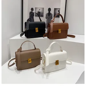Minimalist leather handbags in black, brown, taupe and white with golden S-shaped buckles