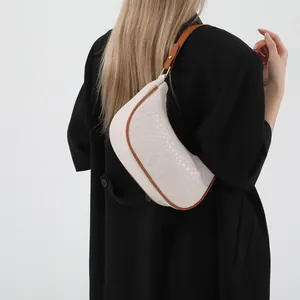 Minimalist white crocodile embossed crescent shoulder bag with brown leather straps