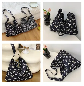 Detail view of canvas tote bags featuring leopard print and butterfly patterns for daily use