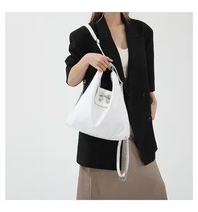 White soft PU tote bag featuring a silver bow buckle and elegant metal chain detail