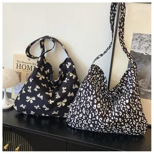 Macro shot of stylish leopard print and bow canvas tote bags on a vintage cabinet