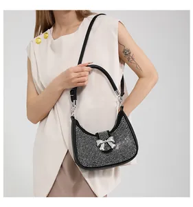 Detail of black rhinestone crescent hobo bag with silver crystal butterfly buckle