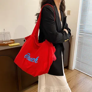 Large red canvas tote bag with blue Beach lettering script for women casual commuting