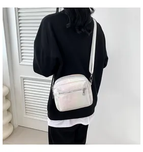 Chic pearl white small crossbody bag for women shown on a model against a white door