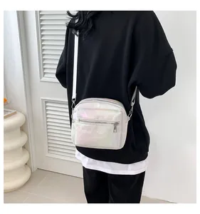 Model wearing a white iridescent crossbody square bag with sleek metallic zippers