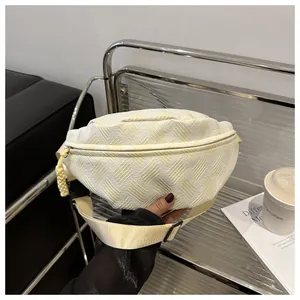 Detail of a beige sling bag featuring woven textures and adjustable nylon strap for women