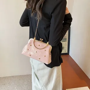 Pink glossy shell handbag with gold heart rivets and chain strap for women