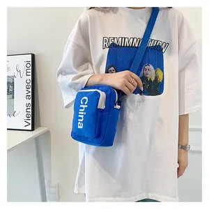 Detailed shot of blue canvas crossbody bag with China lettering and adjustable strap