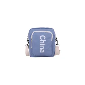 Light blue canvas crossbody square bag with vertical China lettering and white strap