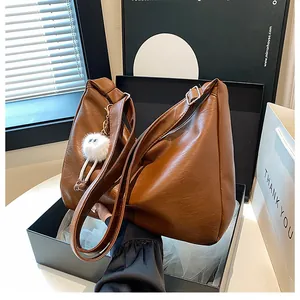 Deep brown large capacity faux leather shoulder bag with cute plush monster charm