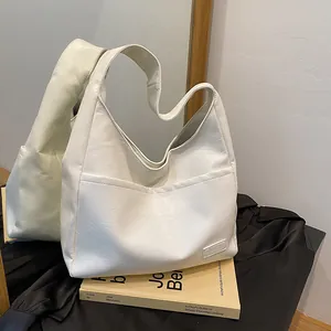 Creamy white hobo tote bag in litchi grain leather with spacious shoulder design