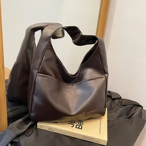 Retro brown oversized faux leather tote bag for daily commute shown in a cozy setting