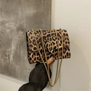 Chic leopard print crossbody bag with gold chain strap and oval metal buckle