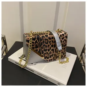 Macro detail of leopard print flap bag featuring gold chain and textured leather finish