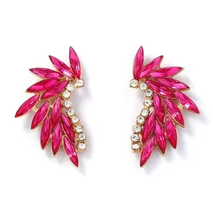 Detailed view of wing-shaped earrings with rose pink and clear marquise-cut crystals